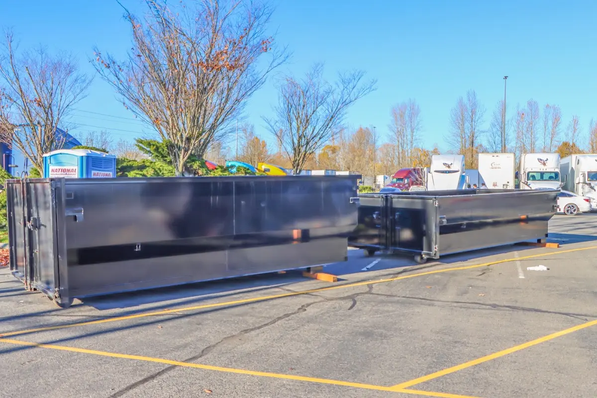 Professional dumpster rental service with roll-off container on residential driveway in Pontotoc